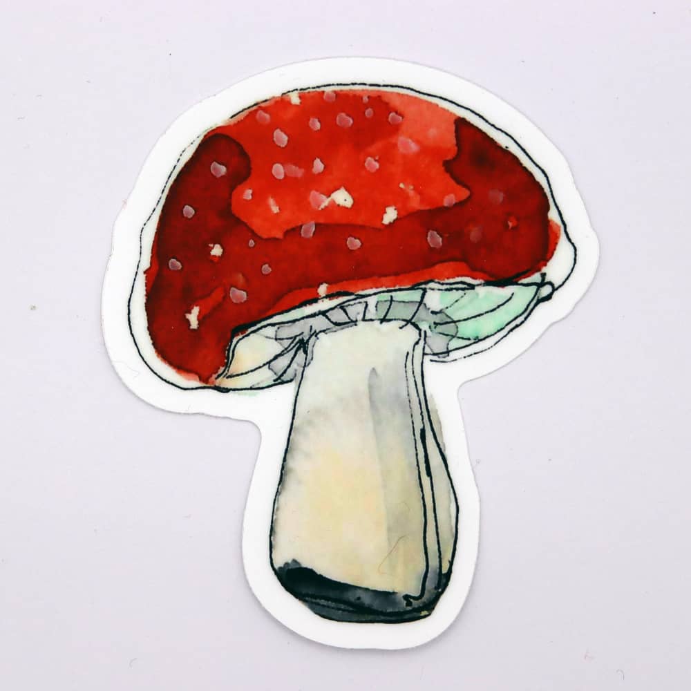 a sticker of a red mushroom on a white background
