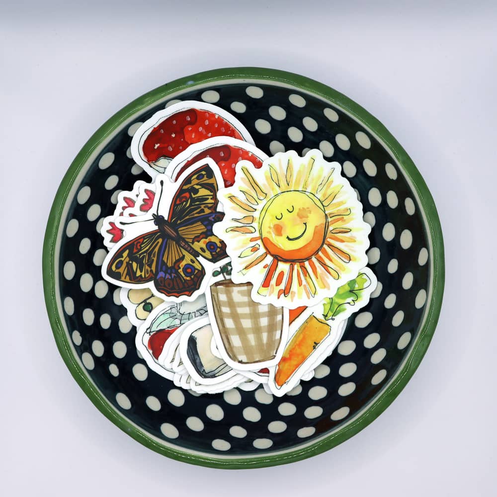 a black and white polka dot plate with stickers on it